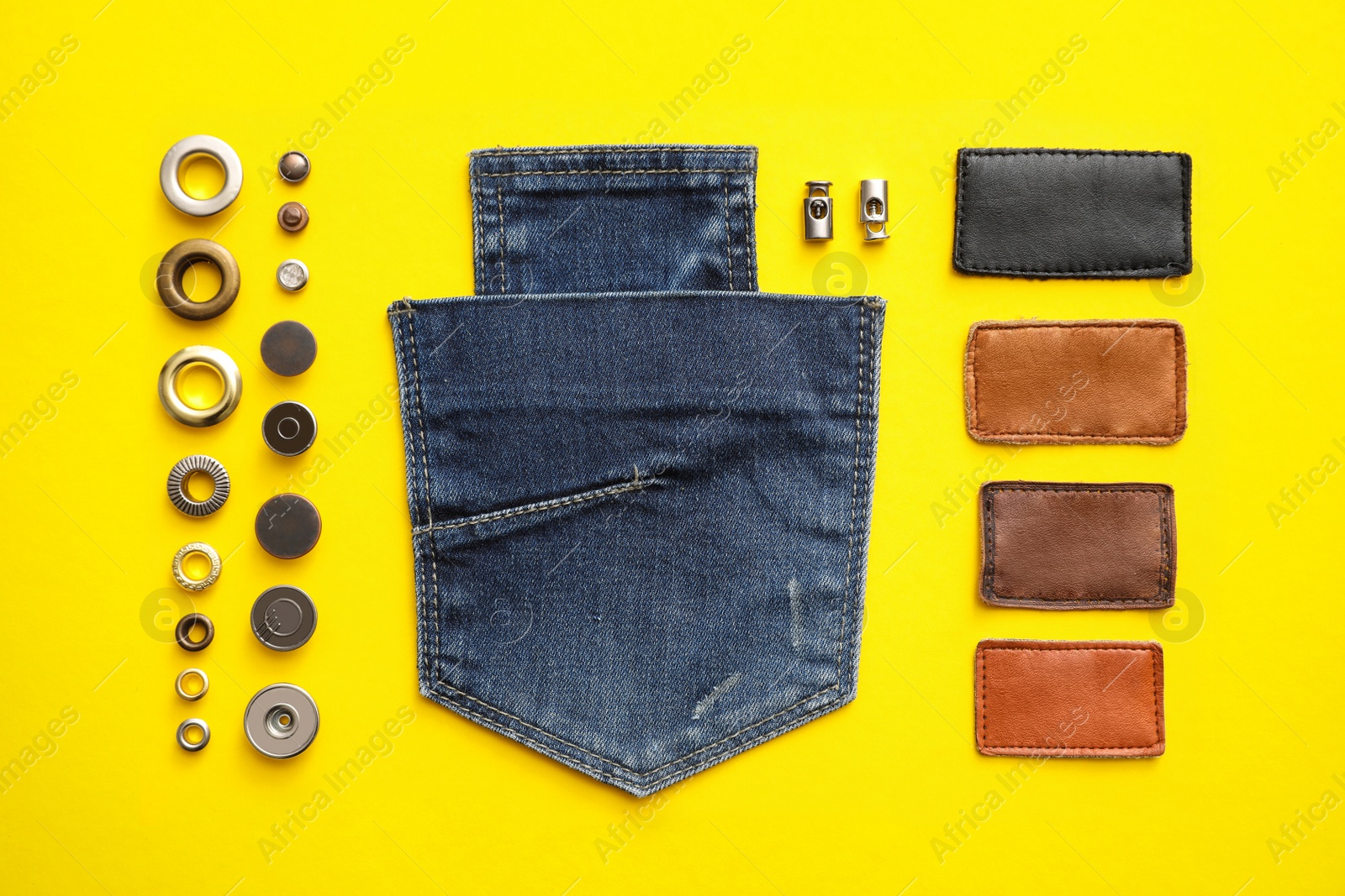 Photo of Flat lay composition with garment accessories and cutting details for jeans on yellow background