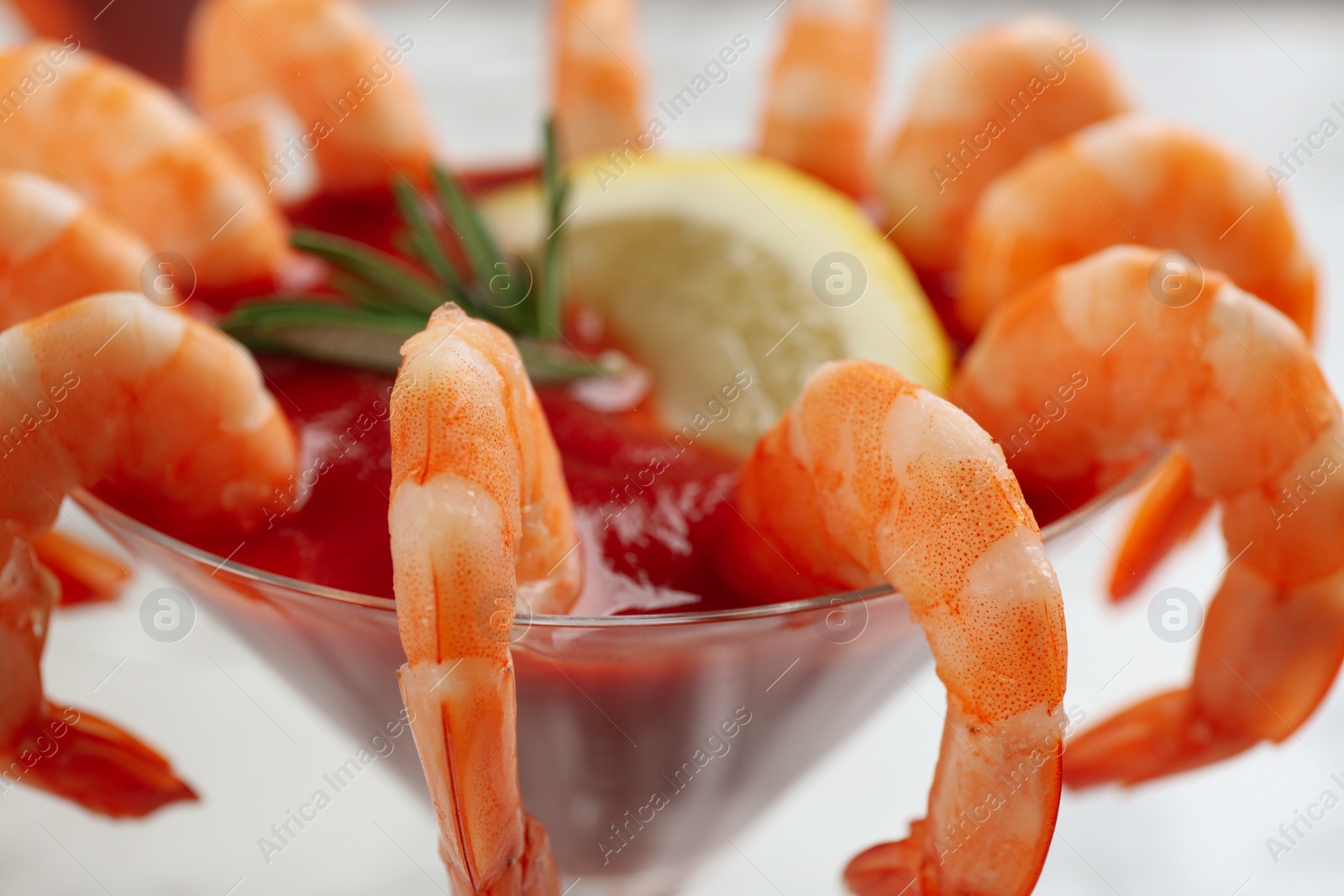 Photo of Delicious shrimp cocktail with tomato sauce, closeup