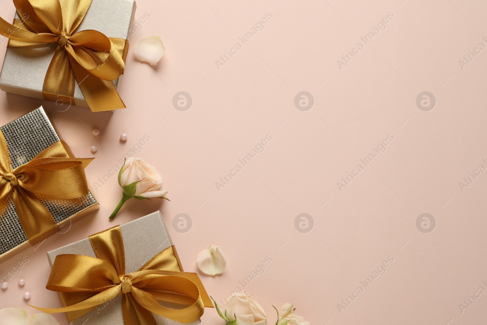 Photo of Beautiful gift boxes and flowers on pink background, flat lay. Space for text