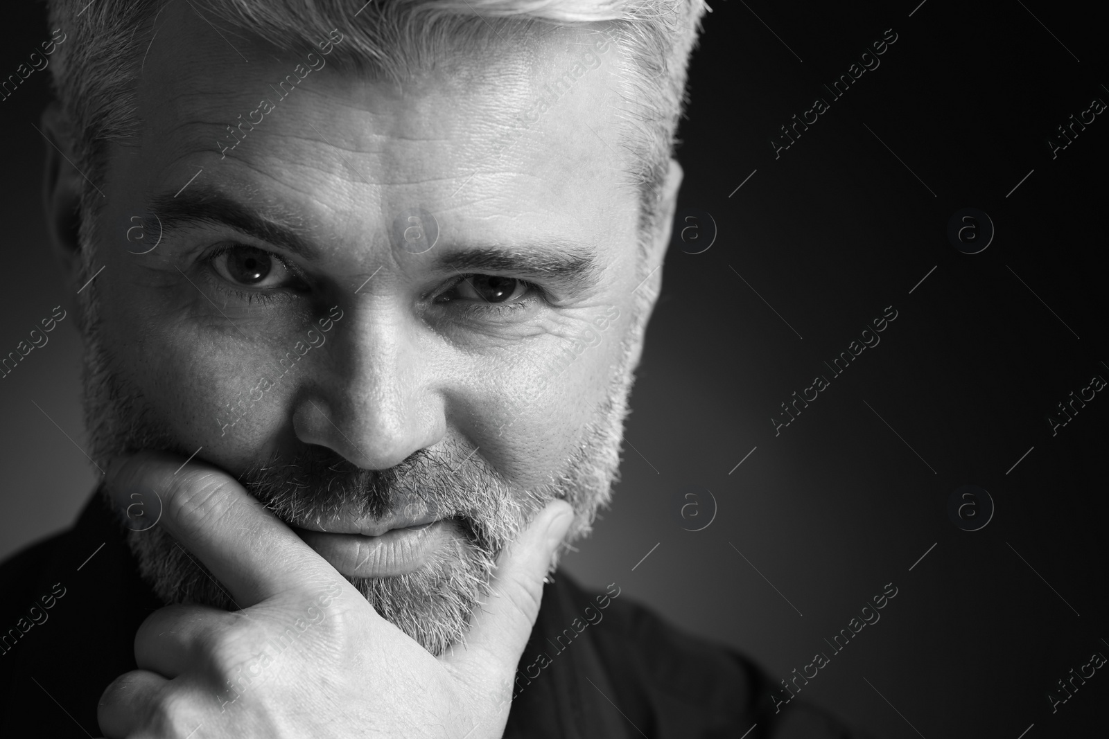 Photo of Portrait of handsome man on dark background, space for text. Black and white effect