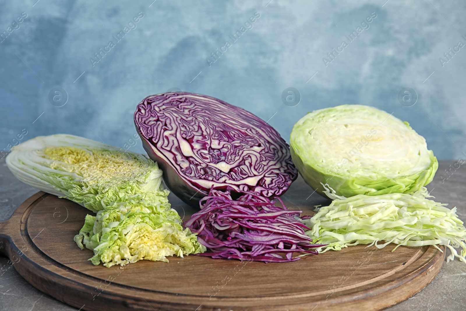 Photo of Different sorts of cabbage on wooden board