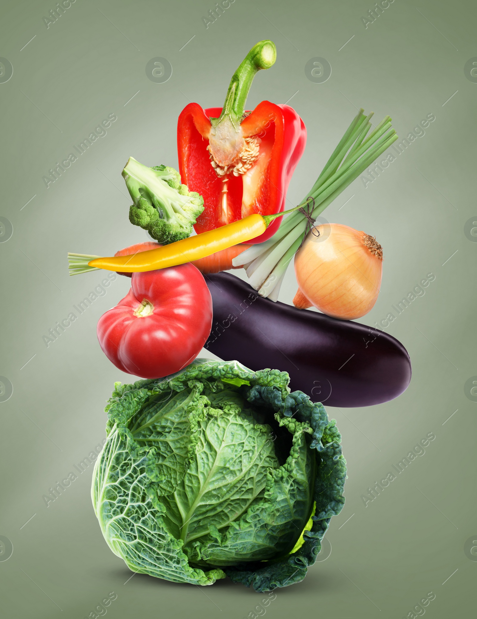 Image of Stack of different fresh vegetables on green grey background