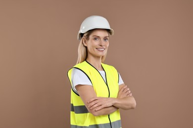 Photo of Engineer in hard hat on brown background