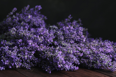Photo of Beautiful fresh lavender flowers on wooden table, closeup