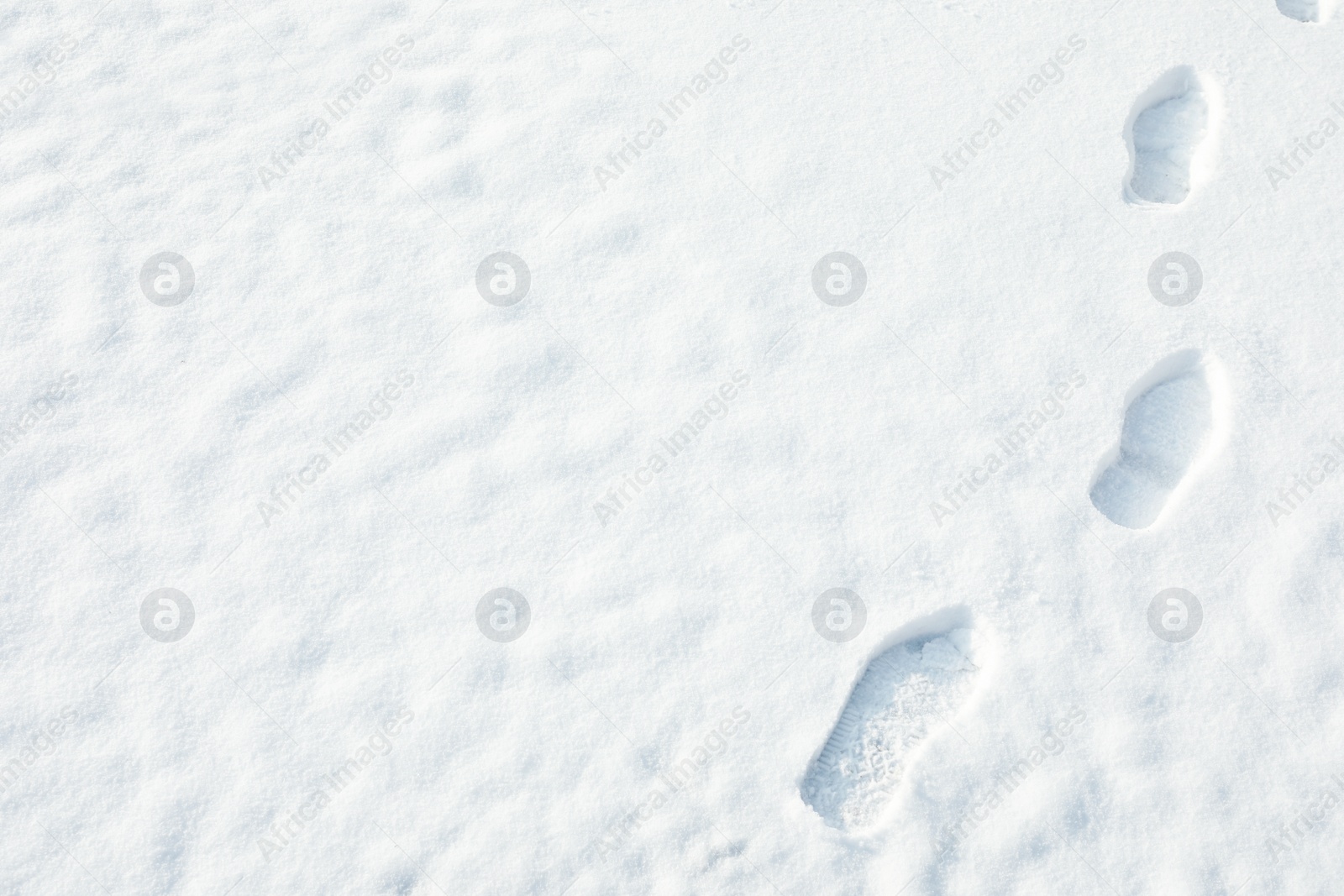 Photo of Footprints on white snow outdoors, space for text. Winter weather