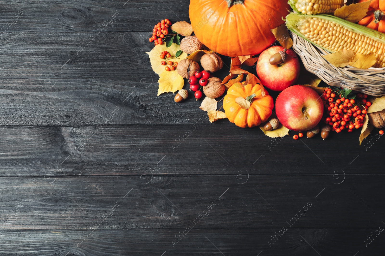 Photo of Flat lay composition with vegetables, fruits and autumn leaves on black wooden table. Thanksgiving Day