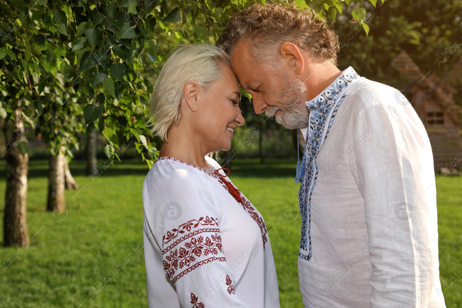 Photo of Happy mature couple in Ukrainian national clothes outdoors