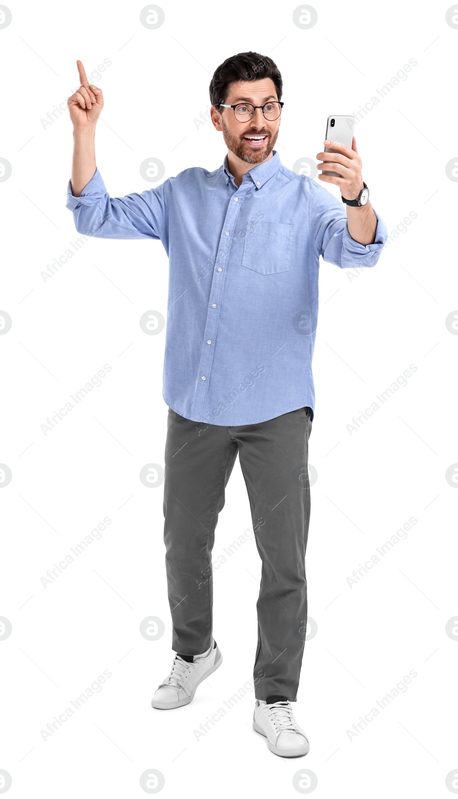 Photo of Smiling man taking selfie with smartphone on white background