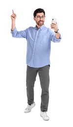 Photo of Smiling man taking selfie with smartphone on white background