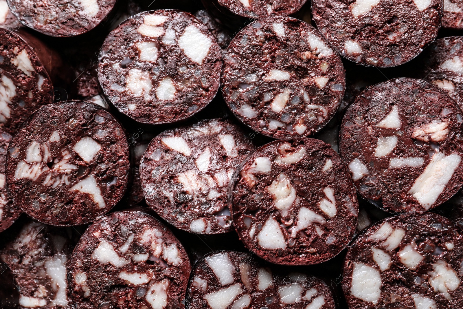 Photo of Slices of tasty blood sausage as background, top view