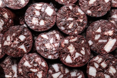 Slices of tasty blood sausage as background, top view