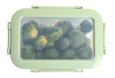 Photo of Frozen Brussels sprouts in plastic container isolated on white, top view. Vegetable preservation