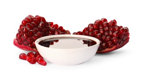 Photo of Bowl of pomegranate sauce and fresh ripe fruit on white background