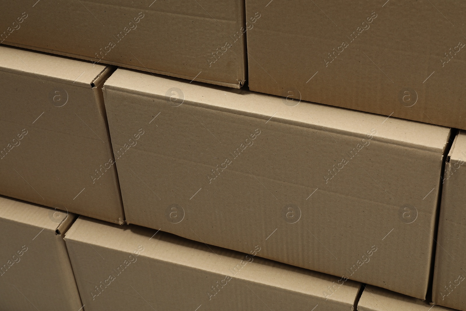 Photo of Stack of many closed cardboard boxes as background