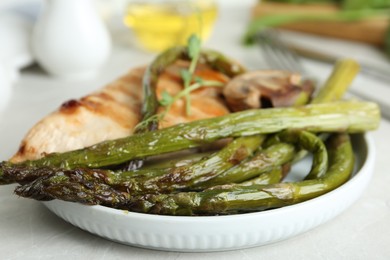 Tasty asparagus with meat on plate, closeup