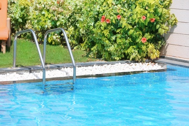 Modern swimming pool with stairs, outdoors