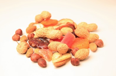 Photo of Pile of mixed dried fruits and nuts on white background, closeup
