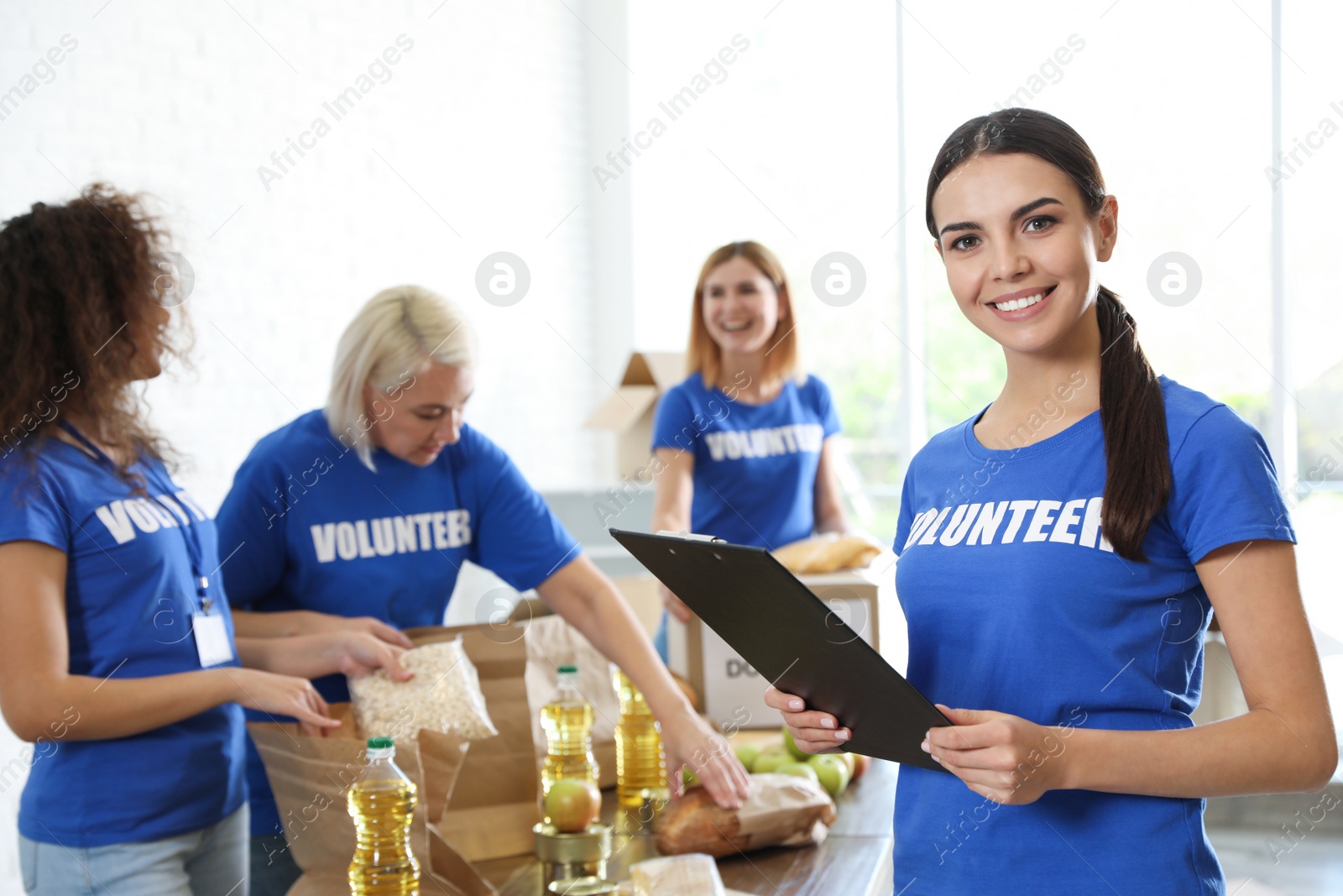 Photo of Portrait of happy female volunteer in uniform indoors