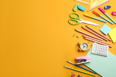 Photo of School stationery on yellow background, flat lay with space for text. Back to school