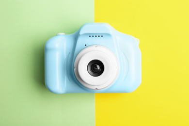 Photo of Light blue toy camera on color background, top view. Future photographer