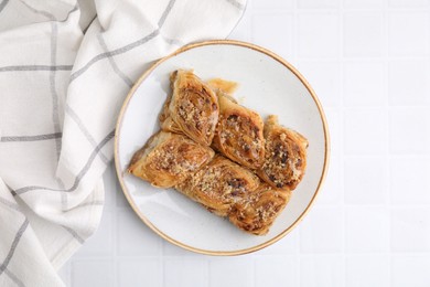 Eastern sweets. Pieces of tasty baklava on white tiled table, top view