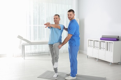 Doctor working with patient in hospital. Rehabilitation exercises