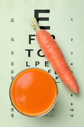 Image of Improving eyesight. Carrot juice on vision test chart, top view
