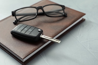 Photo of Composition with male accessories and car key on grey background