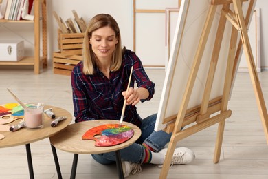 Photo of Beautiful woman painting in studio. Creative hobby