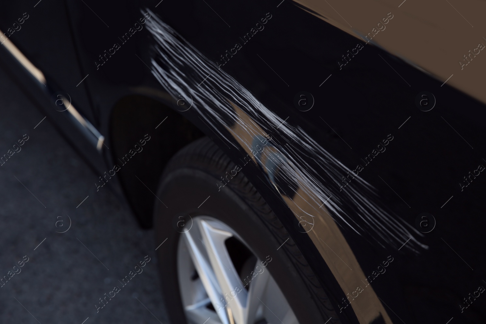 Photo of Modern black car with scratch outdoors, closeup
