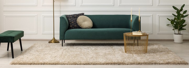 Image of Stylish living room interior with soft beige carpet, side table and sofa. Banner design