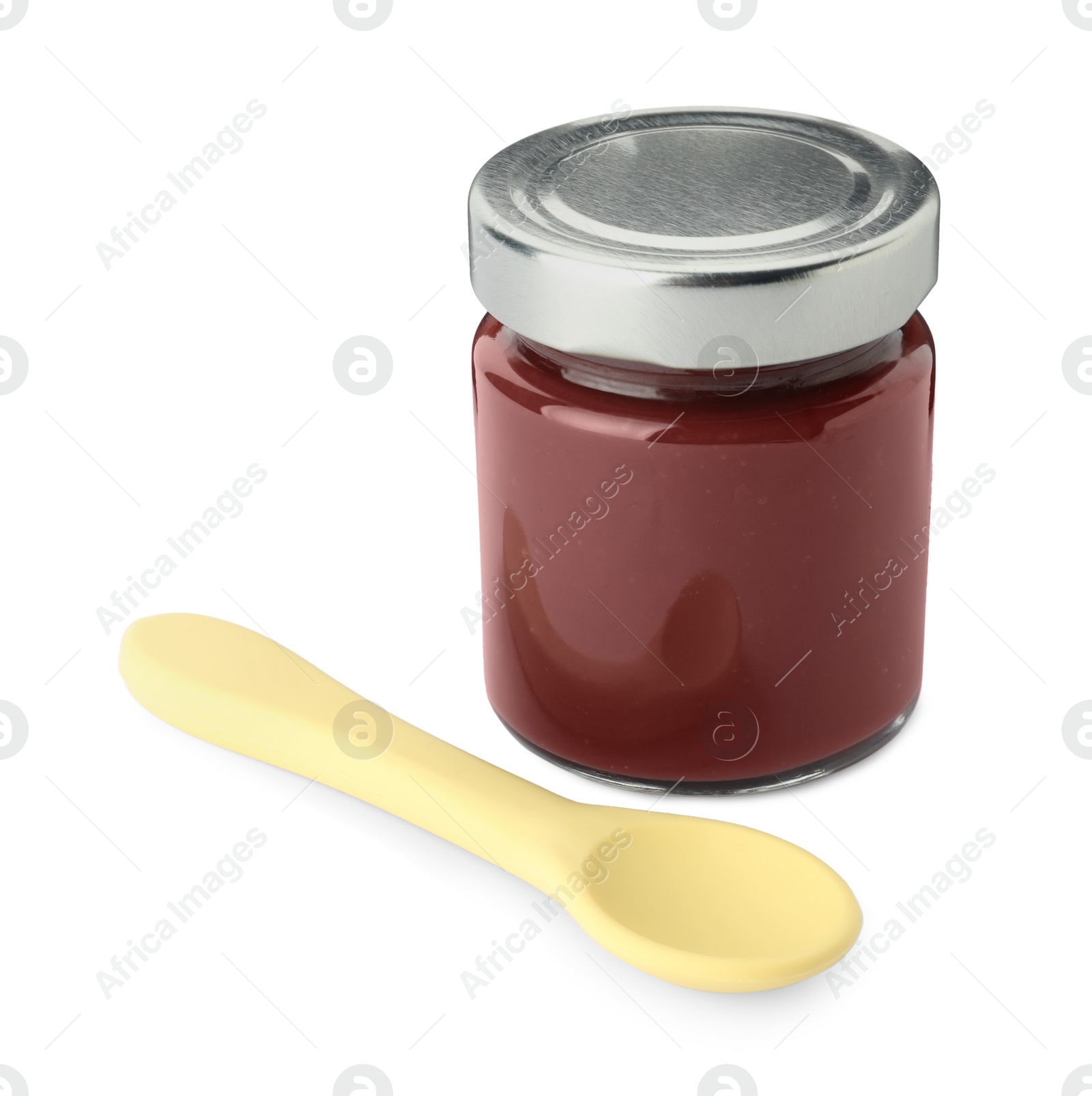 Photo of Jar of healthy baby food and spoon on white background