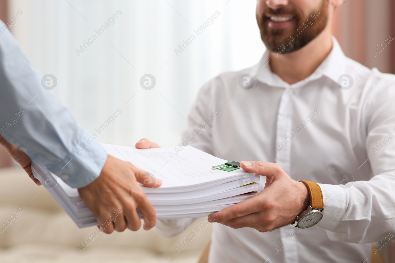 Photo of Woman giving documents to colleague in office, closeup