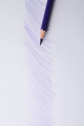 Purple pencil on sheet of paper with drawing, top view