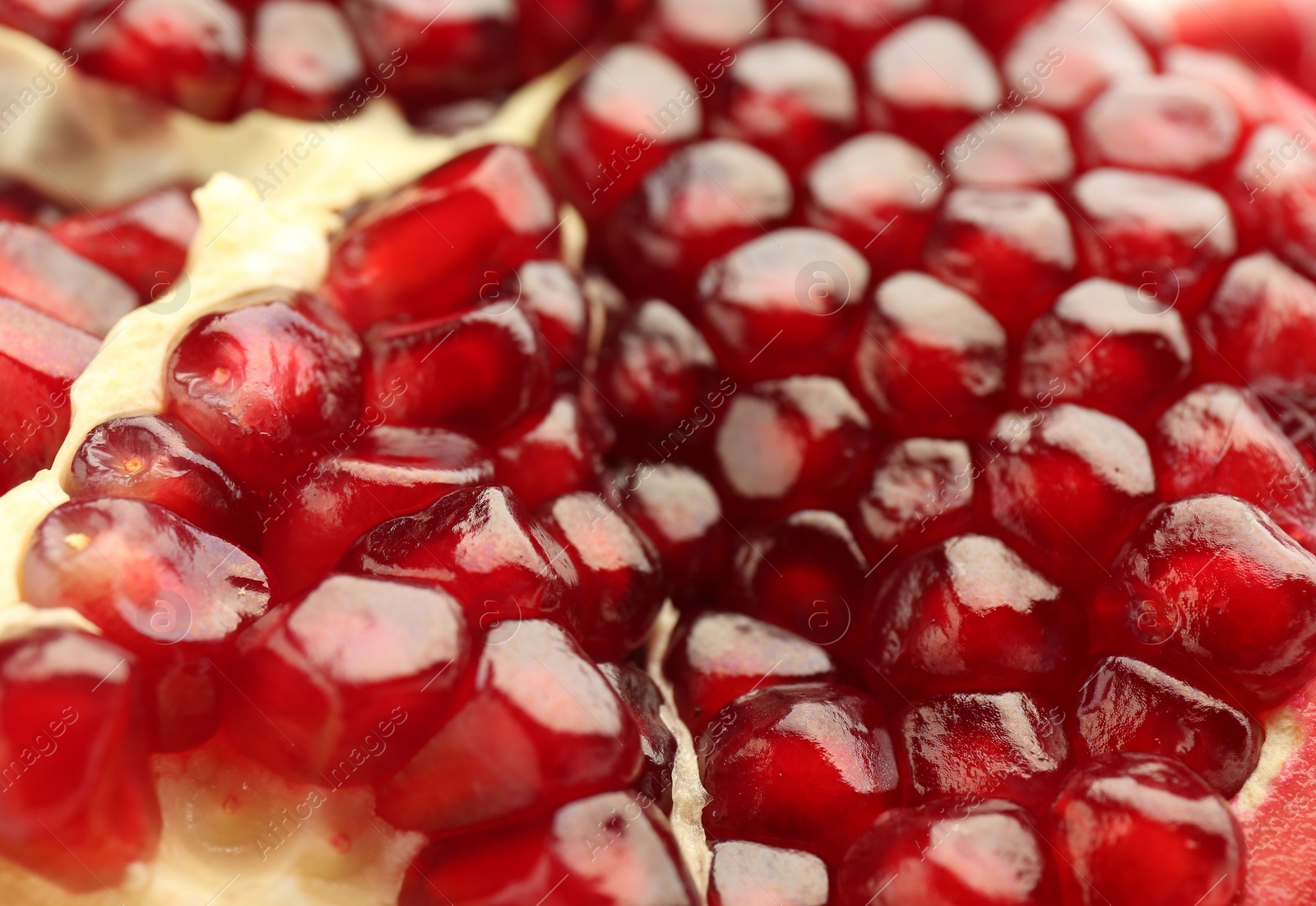 Photo of Ripe juicy pomegranate grains as background, closeup