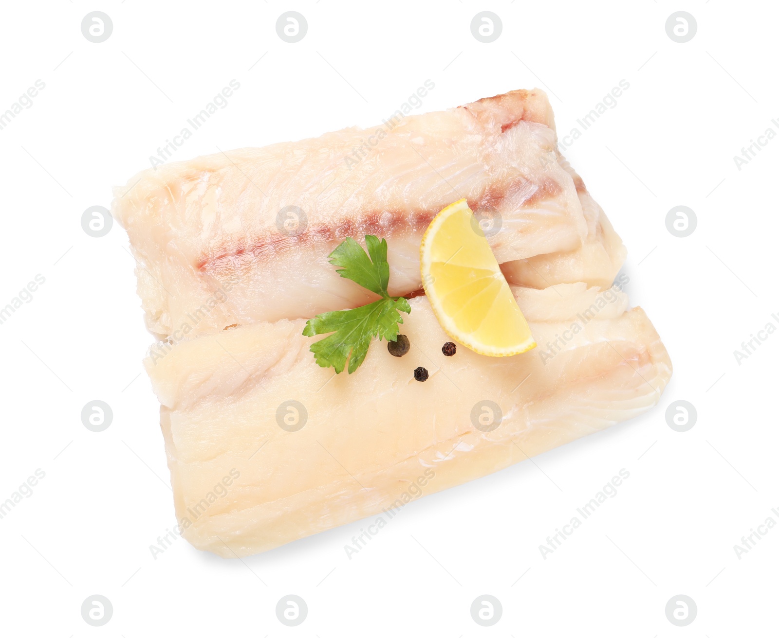 Photo of Pieces of raw cod fish, parsley, peppercorns and lemon isolated on white