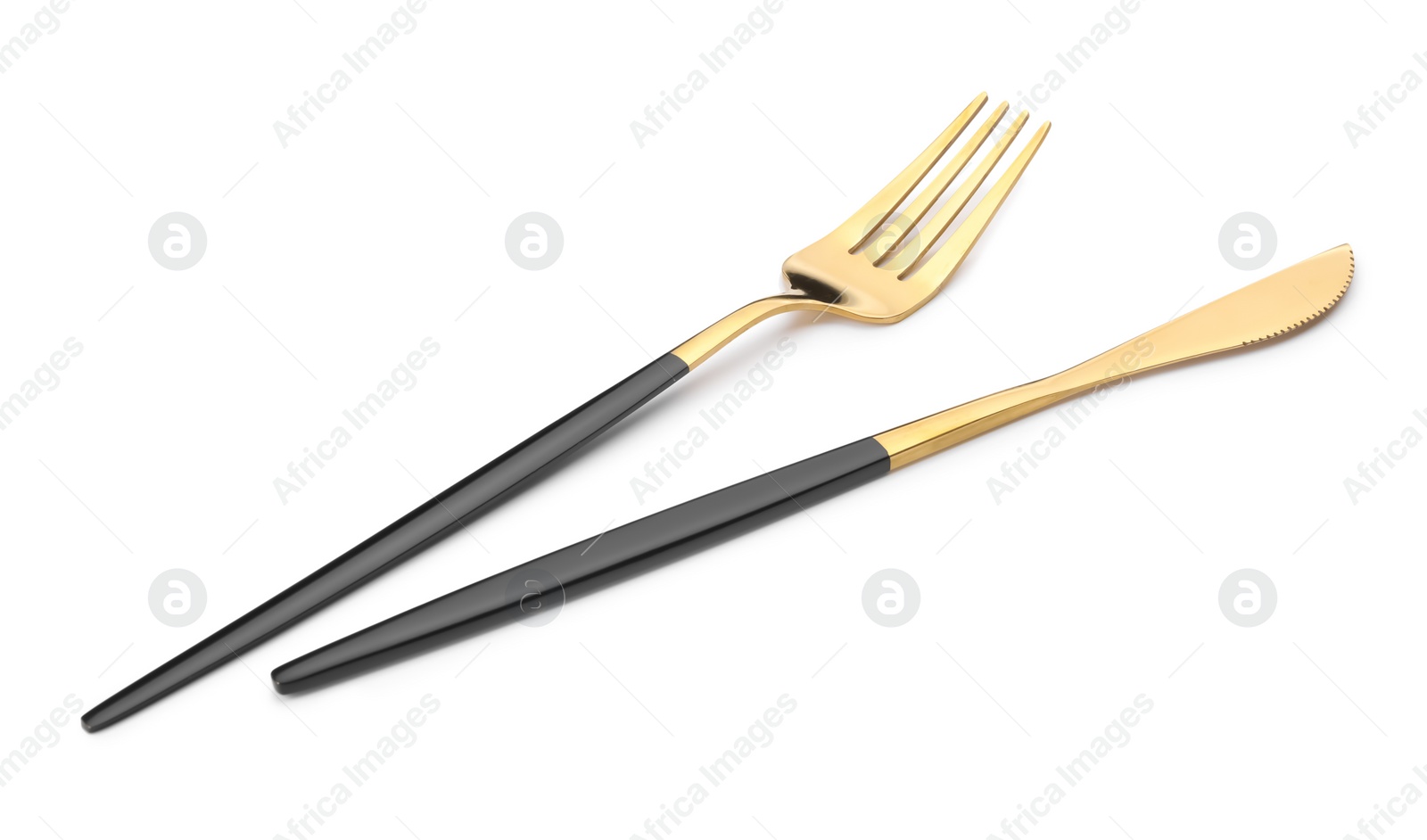 Photo of Shiny golden fork and knife isolated on white. Luxury cutlery