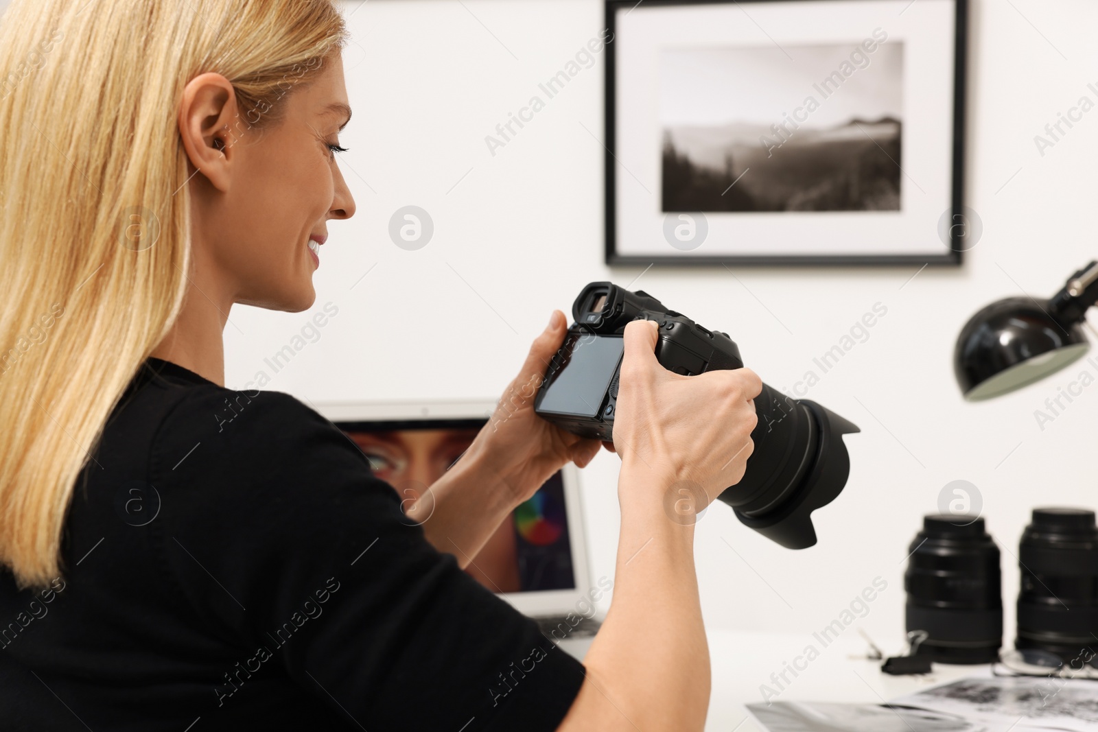 Photo of Professional photographer with digital camera indoors, closeup