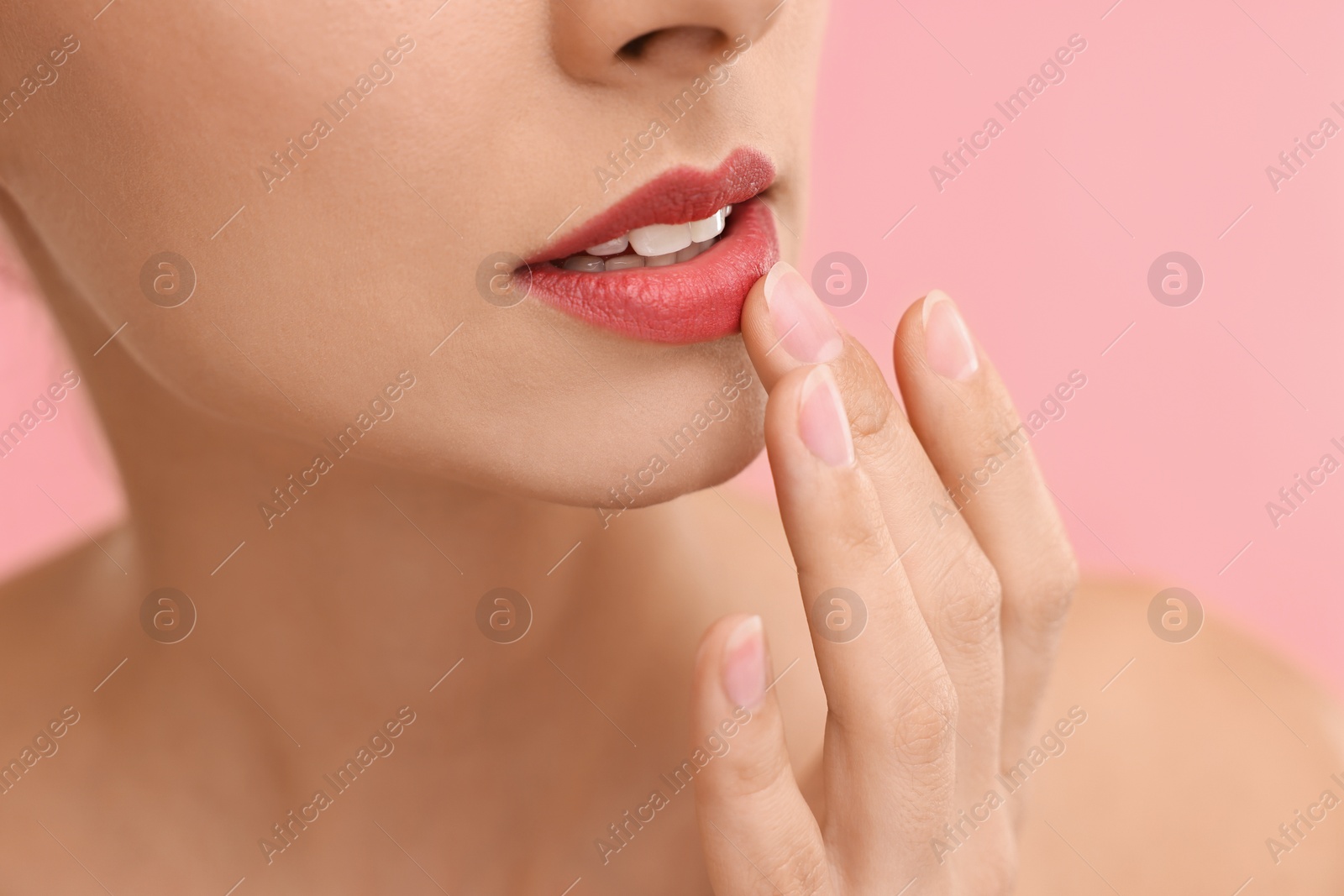 Photo of Woman with beautiful lips on pink background, closeup