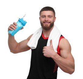 Young man with muscular body holding shaker of protein and showing thumb up on white background