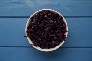 Photo of Tasty red cabbage sauerkraut on light blue wooden table, top view