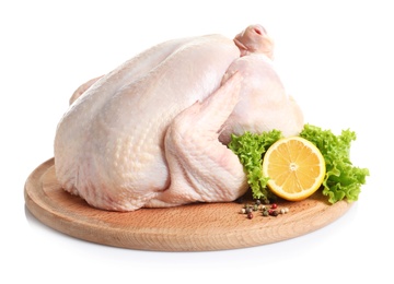 Wooden board with raw turkey and ingredients on white background