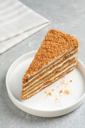 Photo of Slicedelicious layered honey cake on grey table