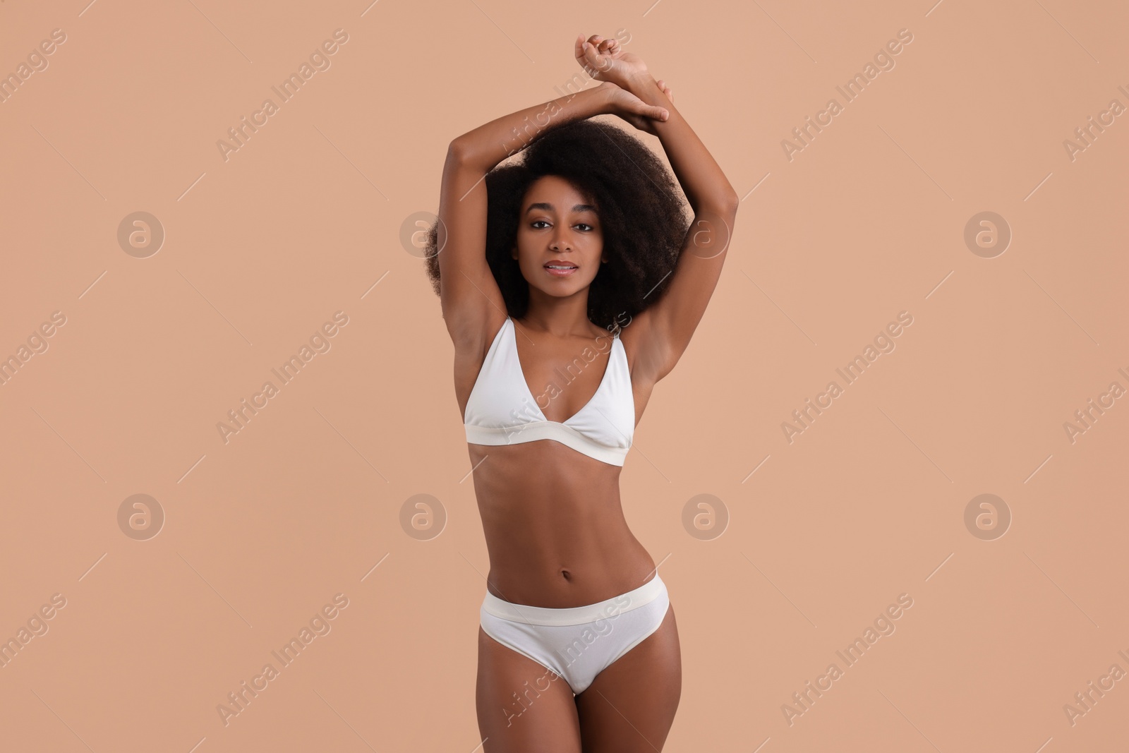 Photo of Beautiful woman in stylish bikini on beige background