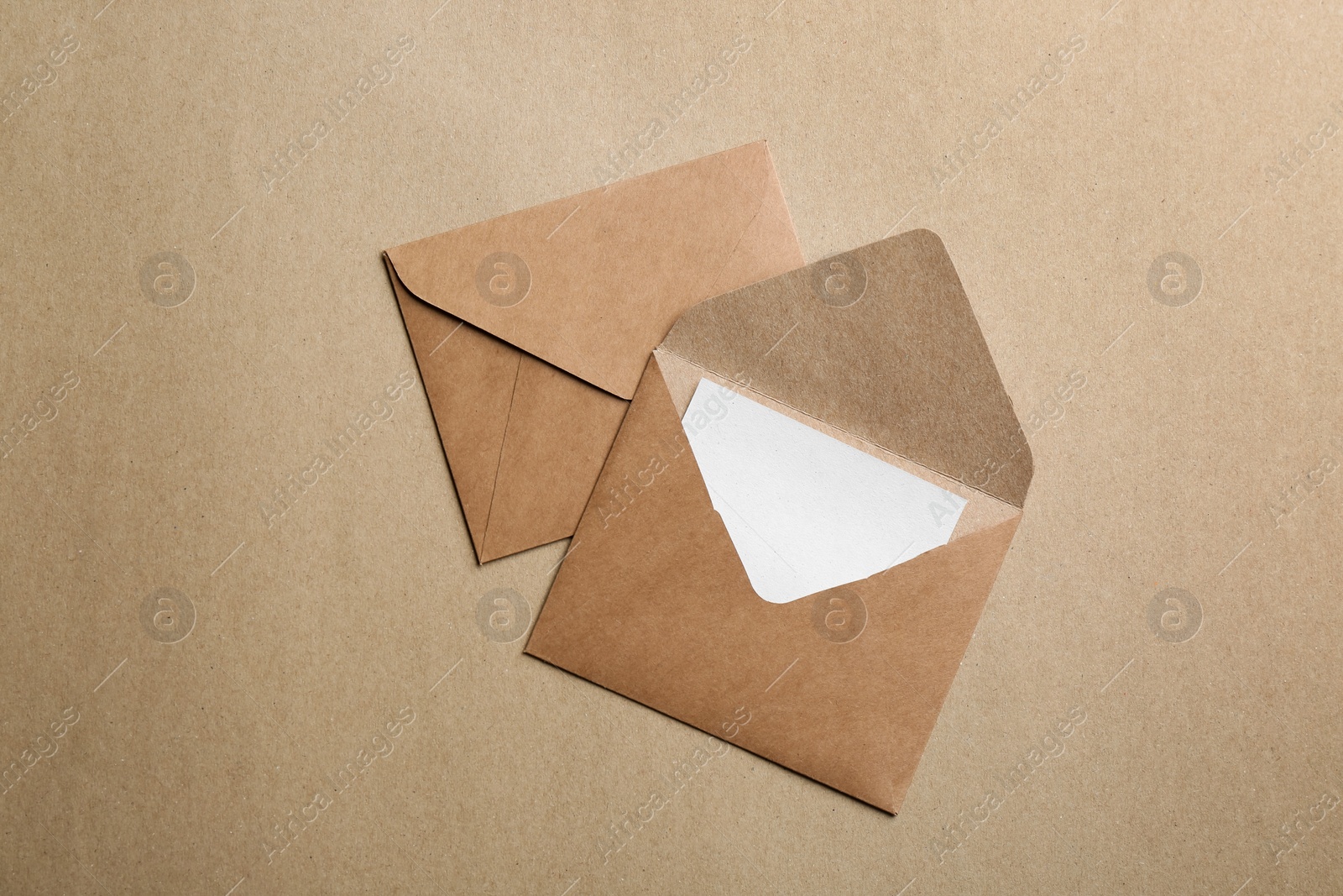 Photo of Brown paper envelopes on color background, flat lay