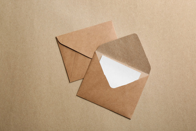 Photo of Brown paper envelopes on color background, flat lay