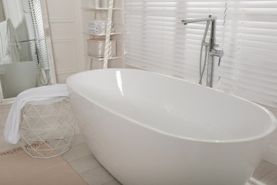 Photo of Minimal bathroom interior with modern white tub