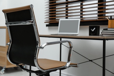 Stylish workplace interior with modern office chair