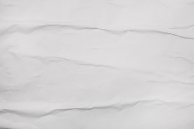 Photo of Top view of white creased blank poster as background, closeup