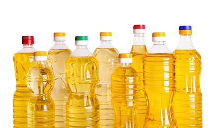 Photo of Bottles of cooking oil on white background